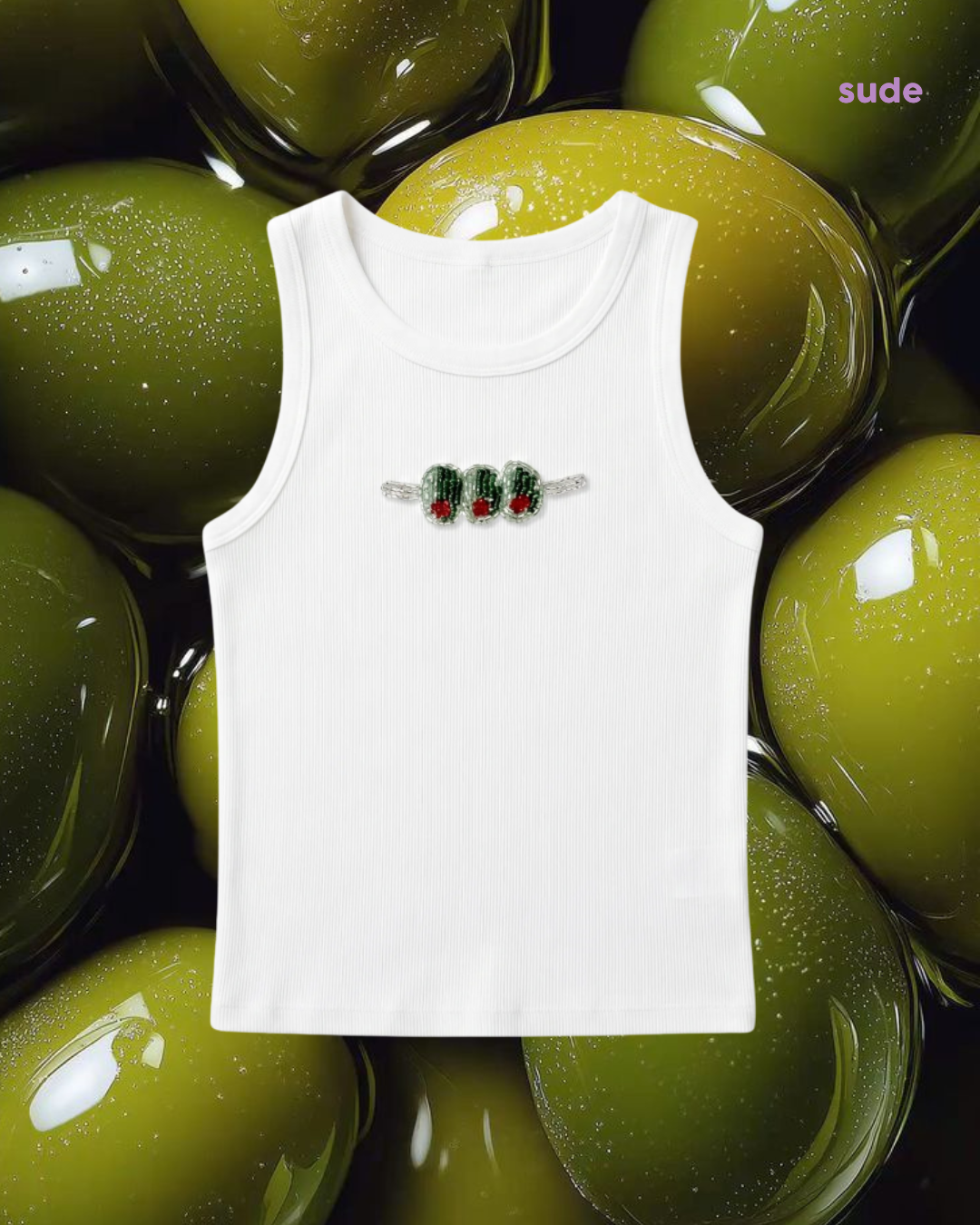 White tank top with embroidered design on a background of olives